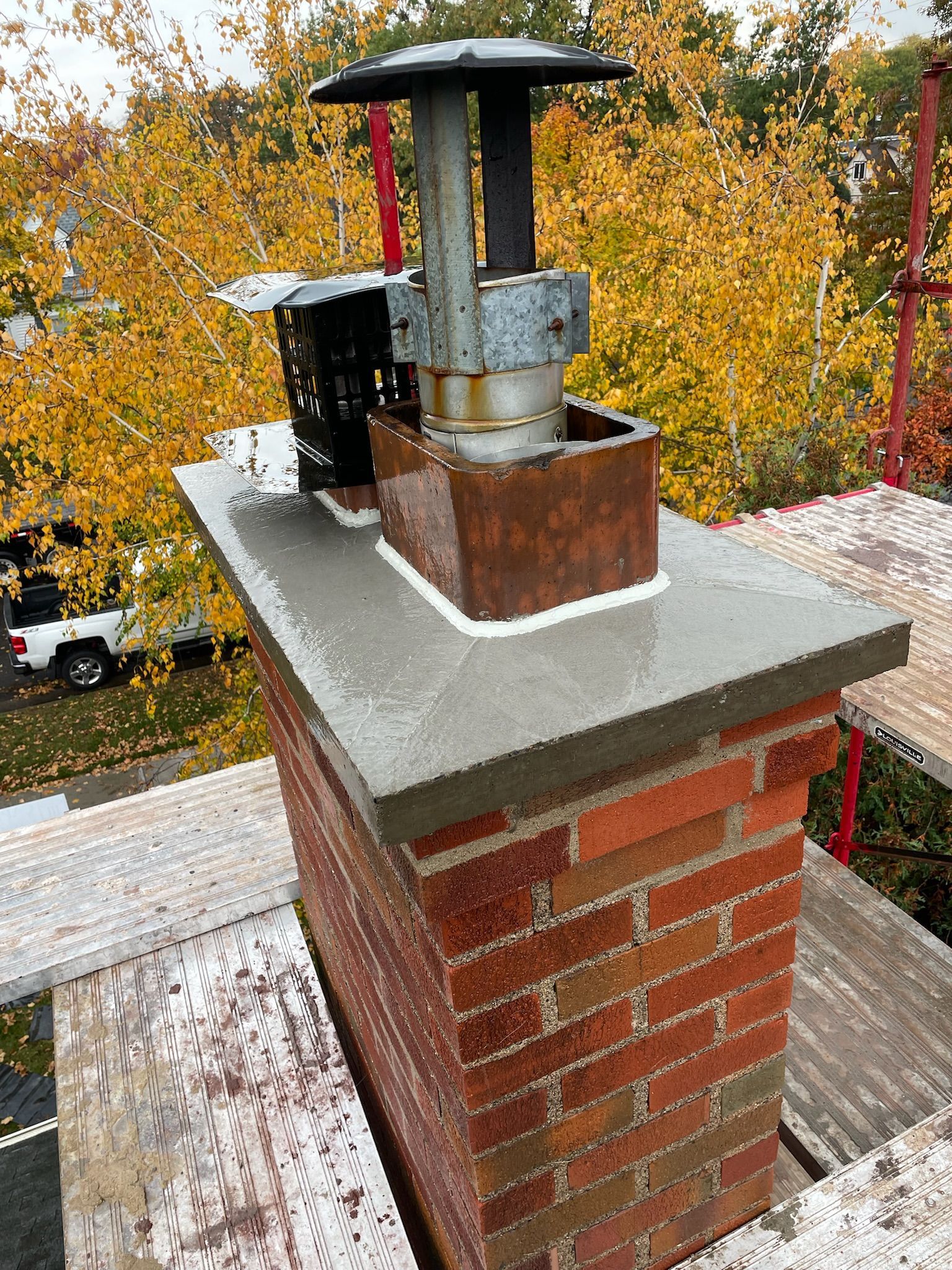 A large brick building with a lot of windows is sitting on top of a lush green lawn.