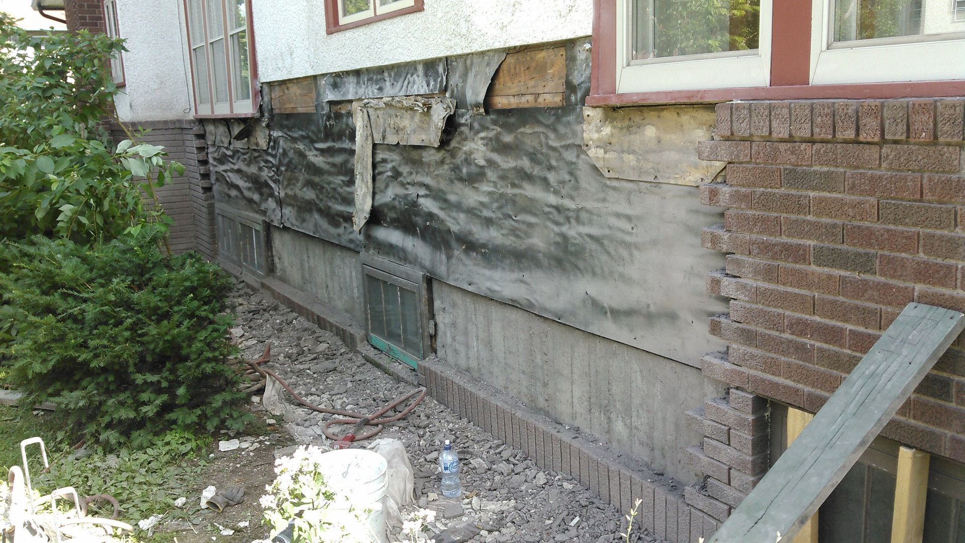 A brick wall of a house that is being remodeled
