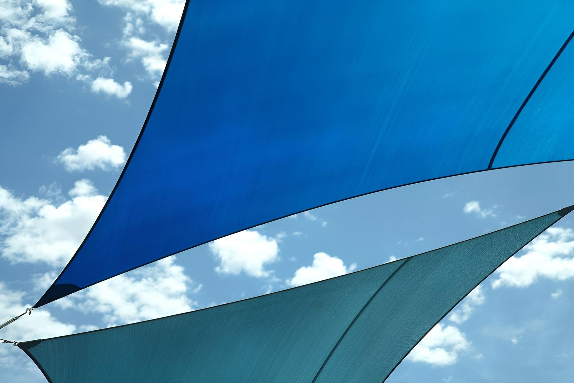 Two Blue Shade Sails Against a Blue Sky with Clouds — Jon Wilson Canvas & Shade in Coffs Harbour, NSW