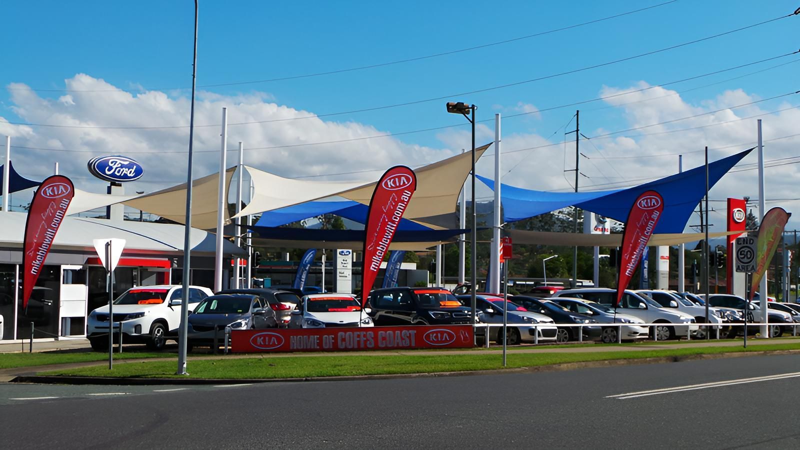 A Lot of Cars Are Parked in Front of A Car Dealership — Jon Wilson Canvas & Shade in Nambucca Heads, NSW