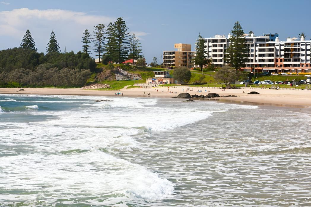 A Beach with A Lot of Buildings in The Background — Jon Wilson Canvas & Shade in Port Macquarie, NSW