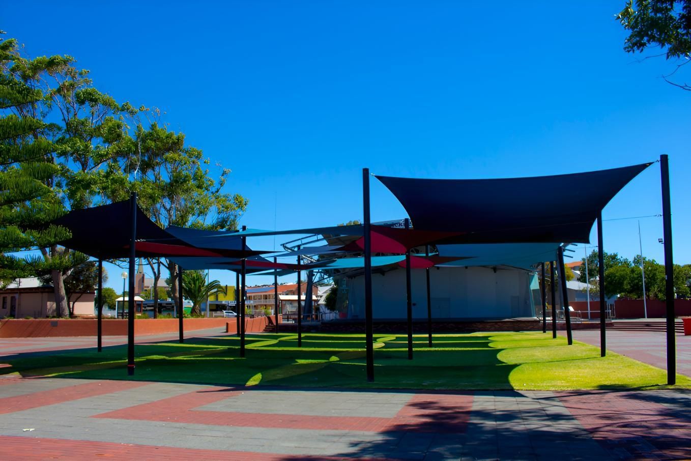 A Row of Umbrellas in A Park with Trees in The Background — Jon Wilson Canvas & Shade in Coffs Harbour, NSW