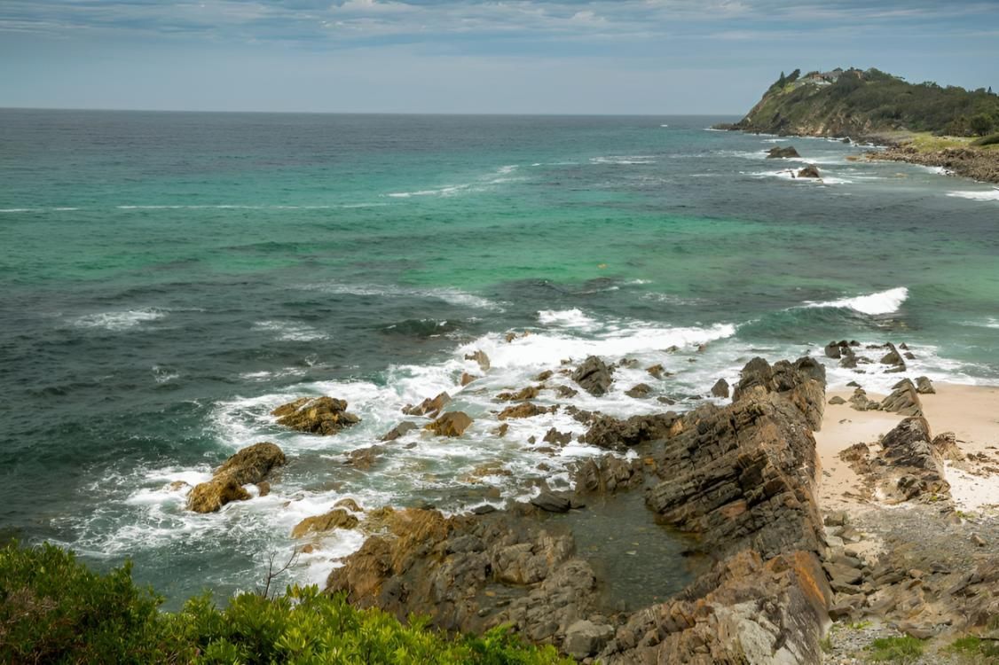 A Cliff Overlooking the Ocean with Waves Crashing on The Rocks — Jon Wilson Canvas & Shade in Taree, NSW