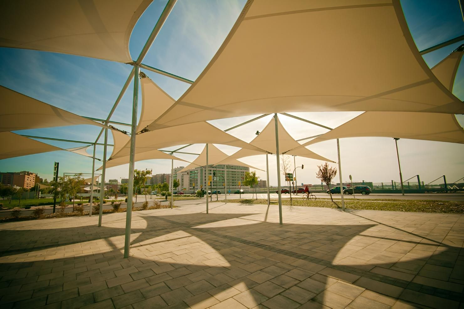 A Group of Umbrellas Are Sitting on Top of A Brick Walkway — Jon Wilson Canvas & Shade in Coffs Harbour, NSW