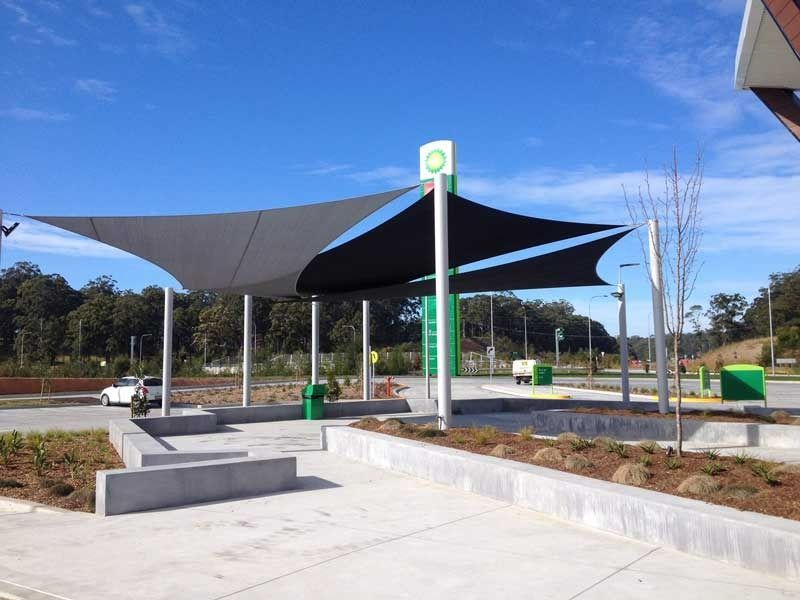 A Bp Gas Station with A Large Umbrella Over It — Jon Wilson Canvas & Shade in Coffs Harbour, NSW