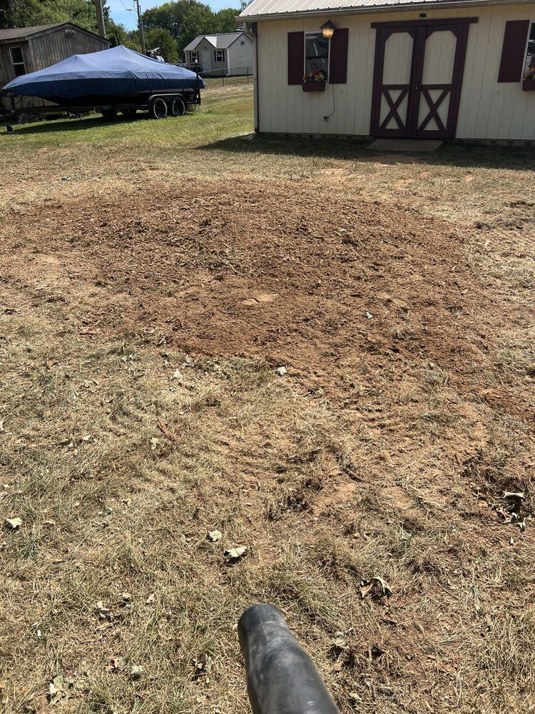 A boat is sitting on a trailer in front of a house.