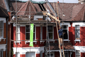 If you need property renovation services in Essex call 01371 821 799 Two men working on scaffolding on a loft conversion