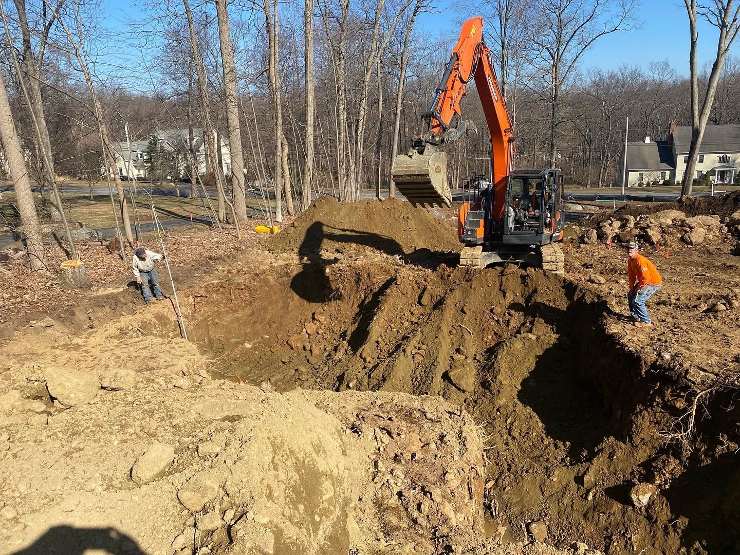 A large excavator is digging a hole in the ground.