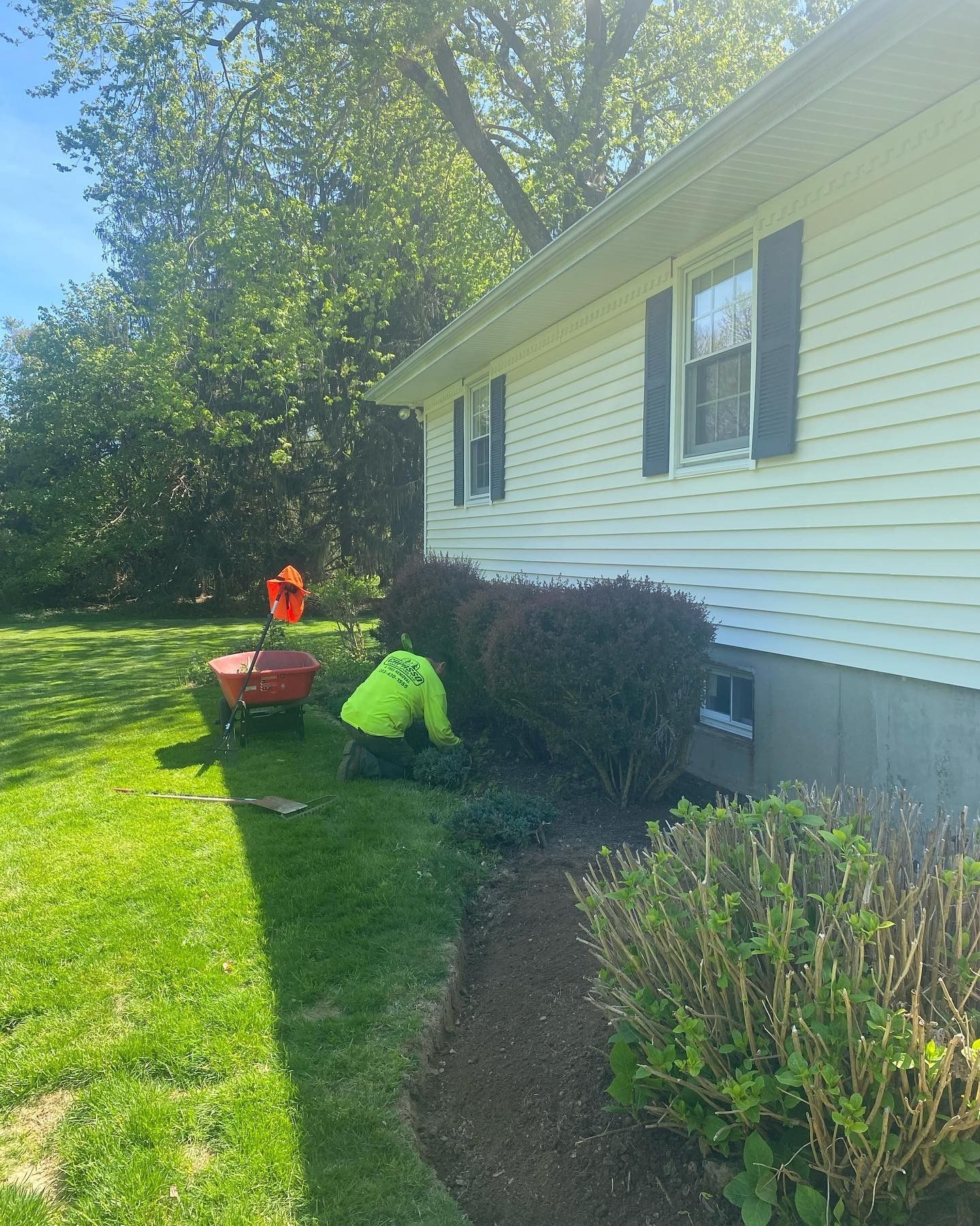 A man is working on the side of a house.