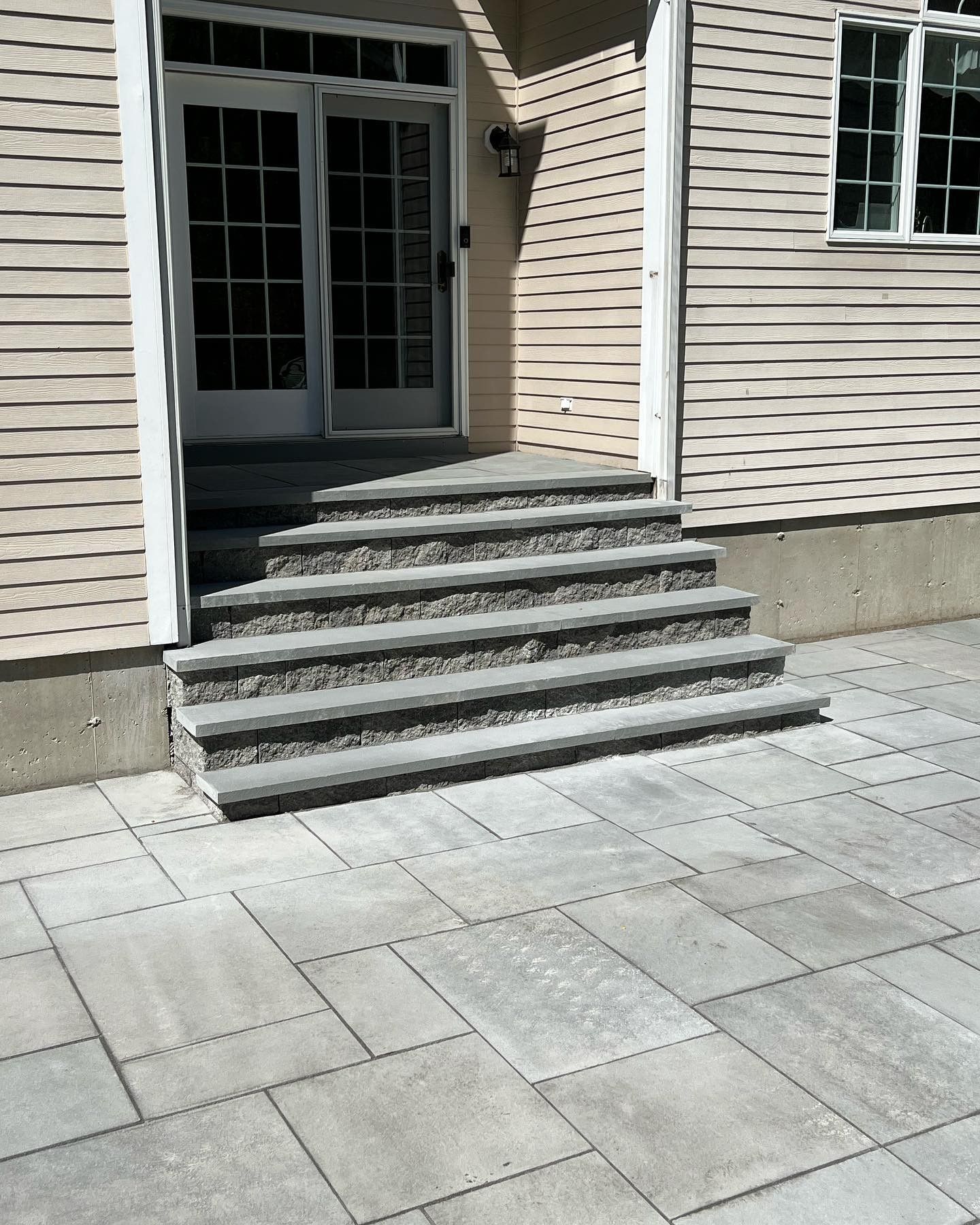 A set of stairs leading up to the front door of a house