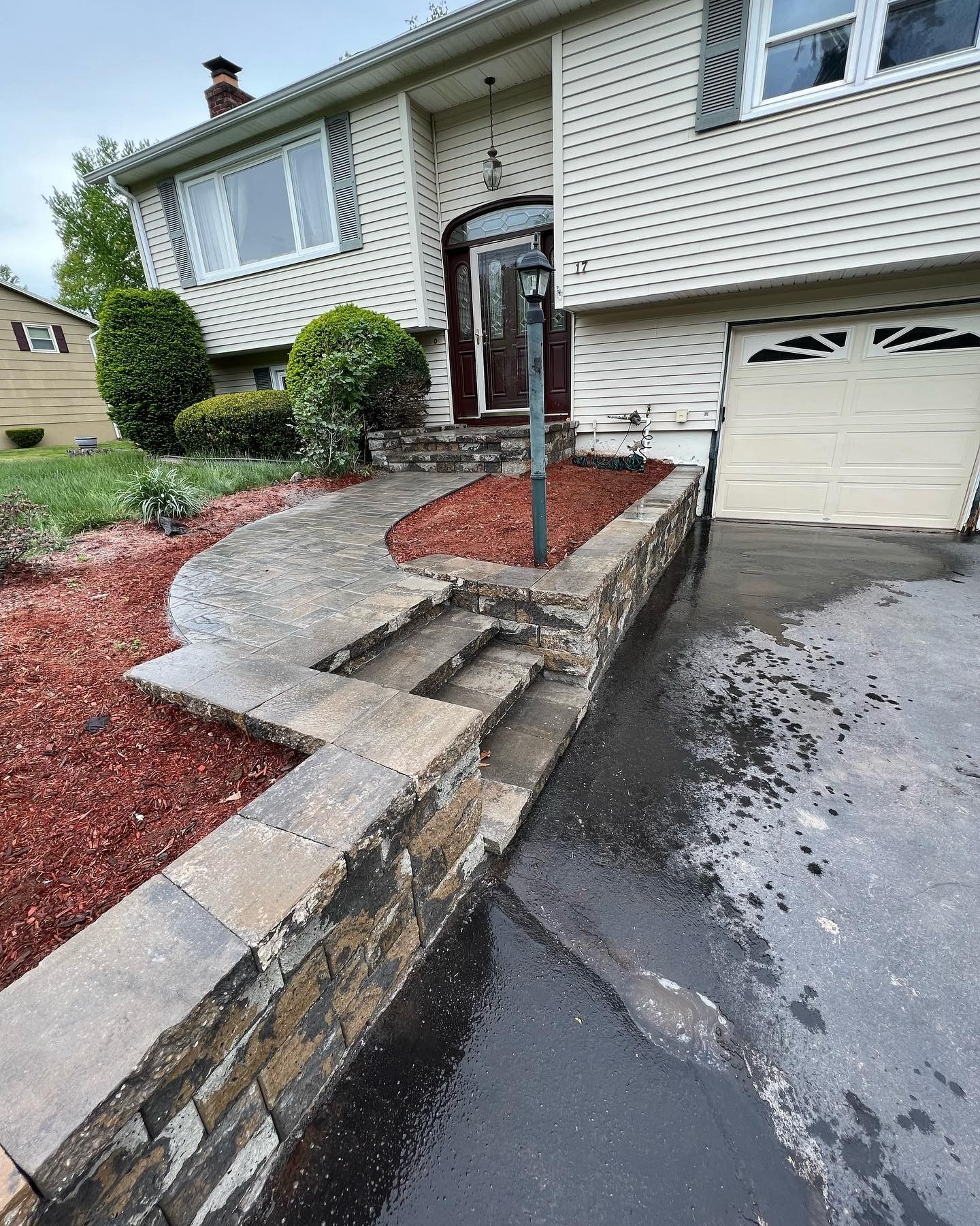 A house with a stone walkway leading to the front door.