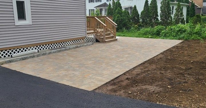 A house with a patio and stairs in front of it.