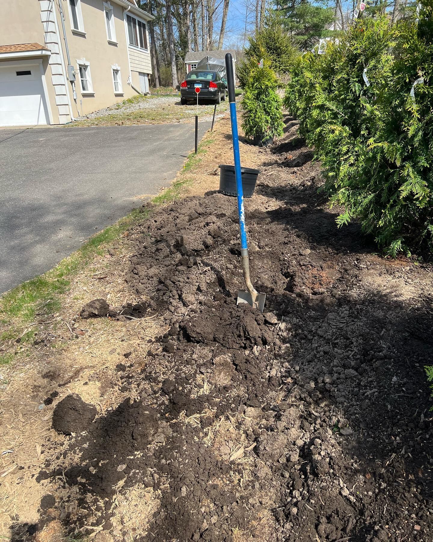 A shovel is sitting in the middle of a pile of dirt.