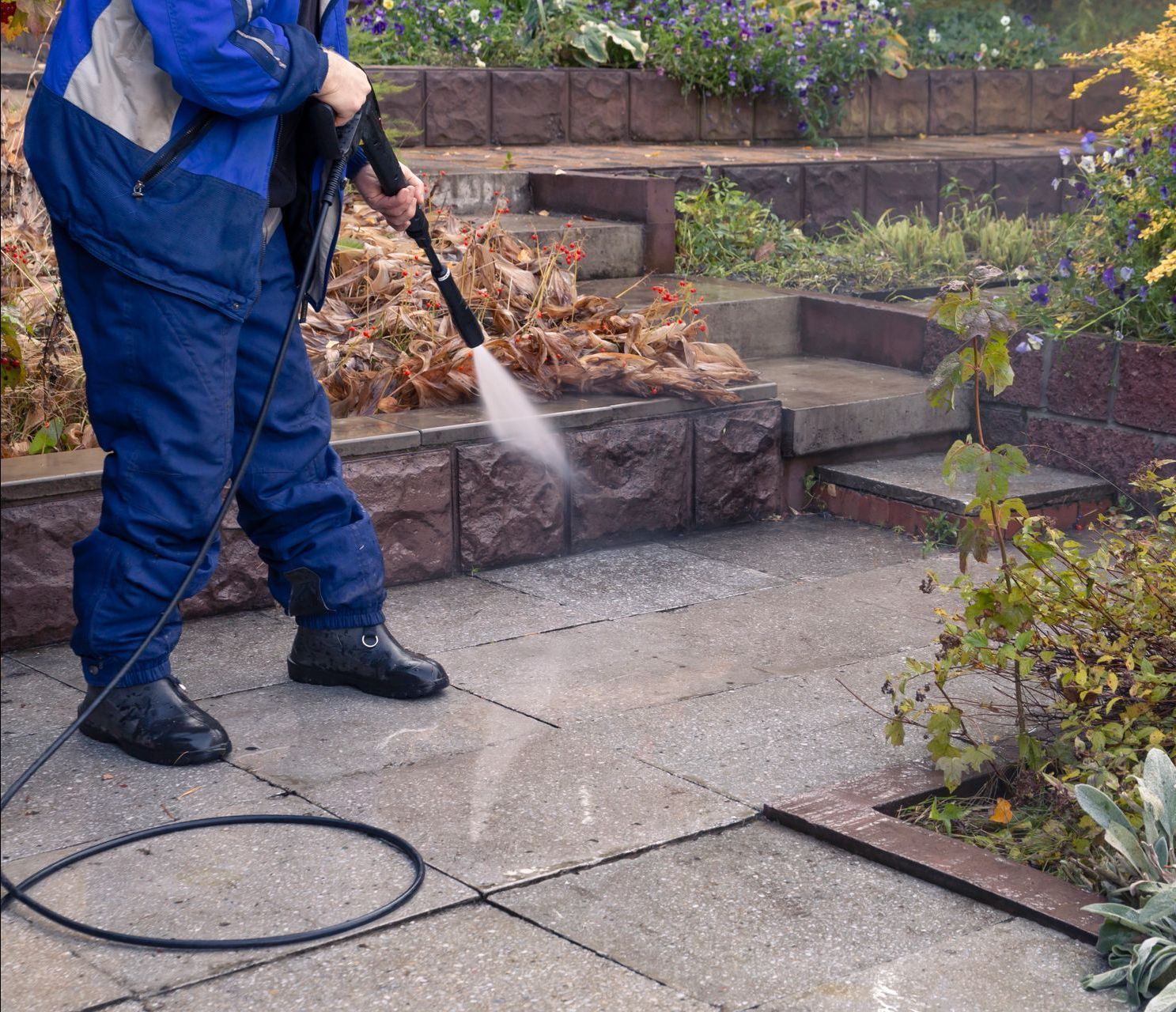 a man is using a high pressure washer to clean a patio