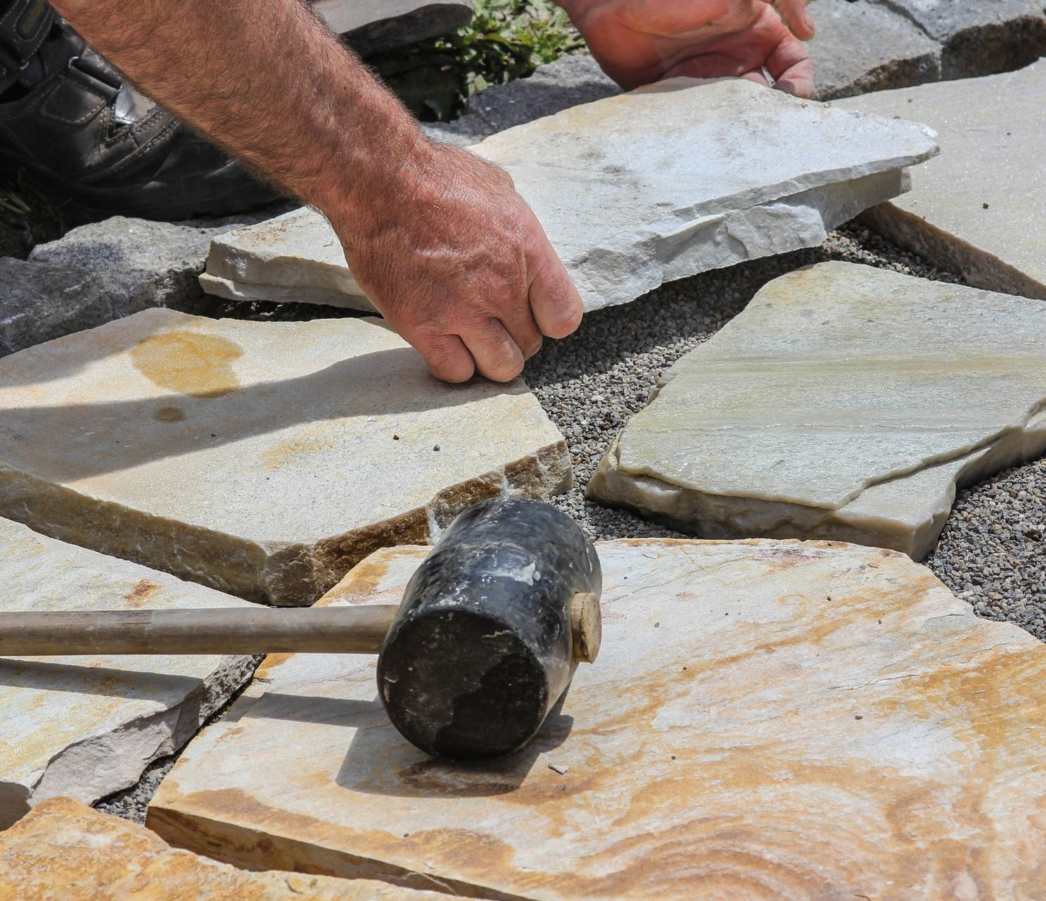 a person is using a hammer to hammer a piece of stone