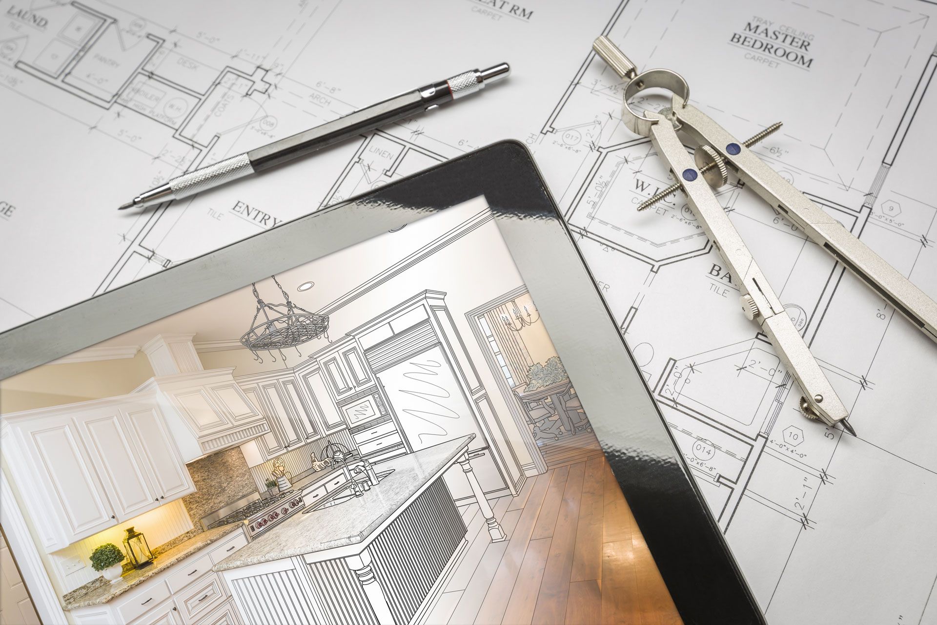 Architectural blueprint workspace with tablet, compass, and pencil on a drafting table