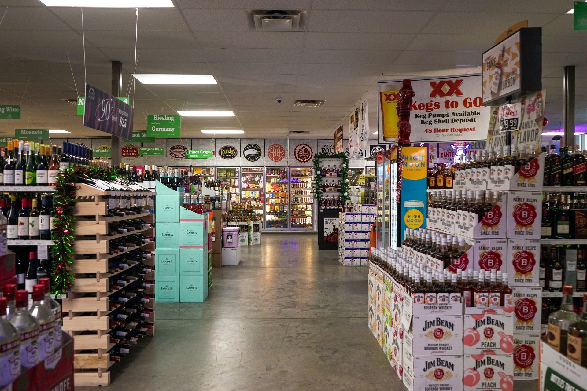 Interior of a liquor store with various bottles and displays, lit by overhead lights.