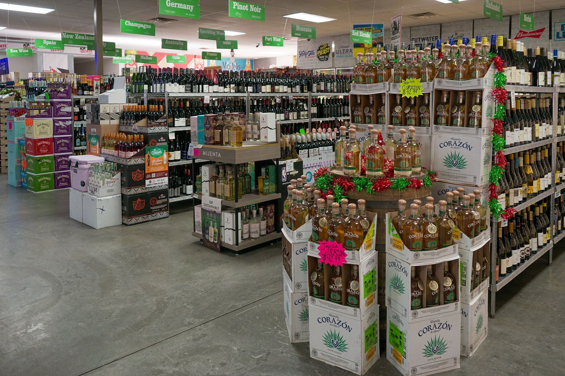 Liquor store interior with various bottles on shelves and display.