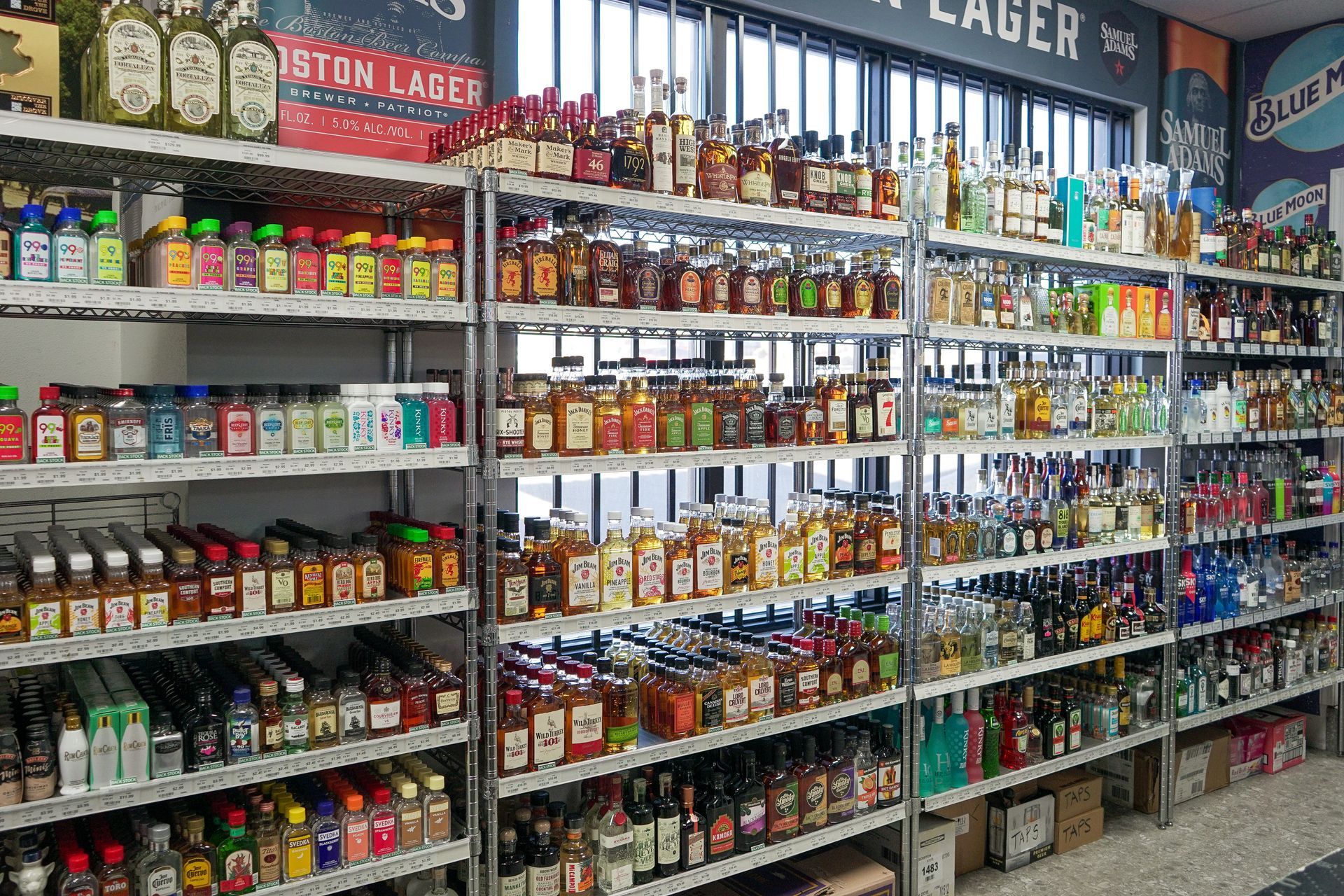 Shelves stocked with various liquor bottles inside a store.