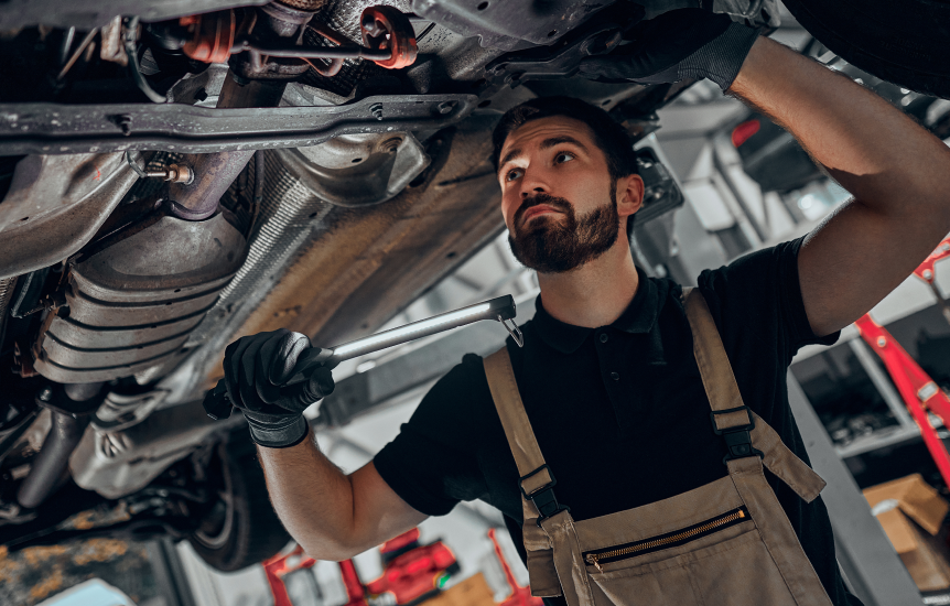 Man repairing underneath car | Hutch's Total Car Care & Transmission Specialists