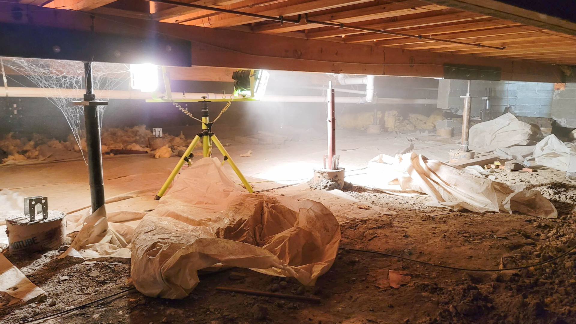 There is a light on a tripod in the basement.