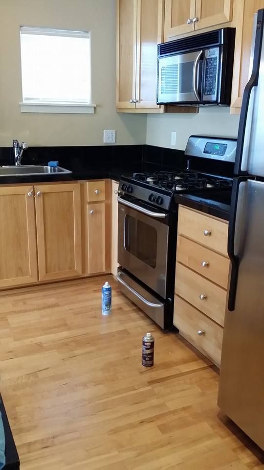 A kitchen with stainless steel appliances and wooden cabinets