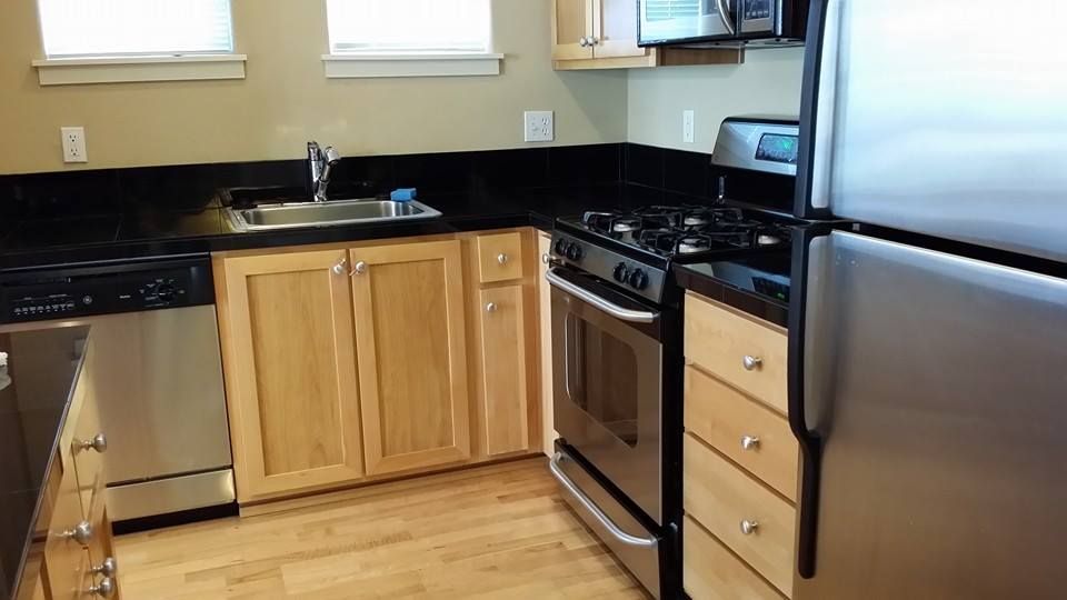 A kitchen with stainless steel appliances and wooden cabinets