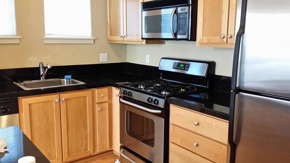 A kitchen with stainless steel appliances and wooden cabinets