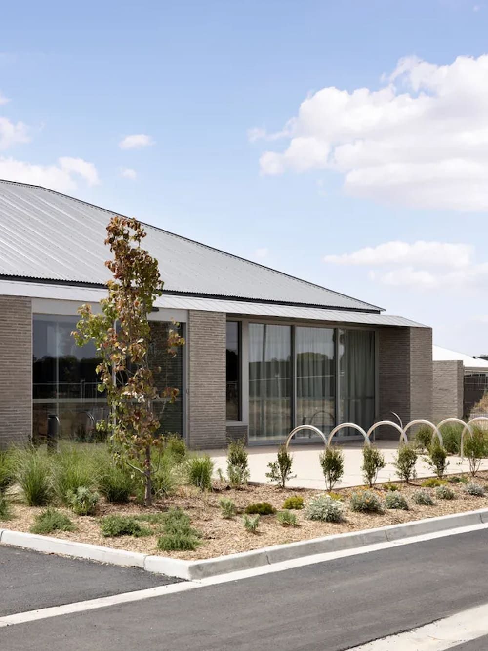 A House With a Gray Roof and a Lot of Windows — Andergrove Plumbing & Drainage Pty Ltd In Richmond, QLD