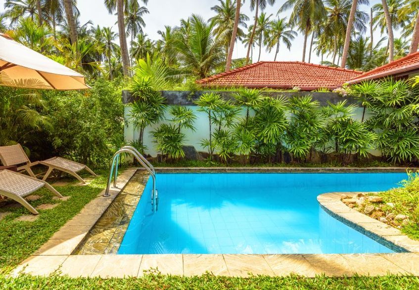 There is a Large Swimming Pool in the Backyard of a House Surrounded by Palm Trees — Lismore Poolscene in Lismore, NSW