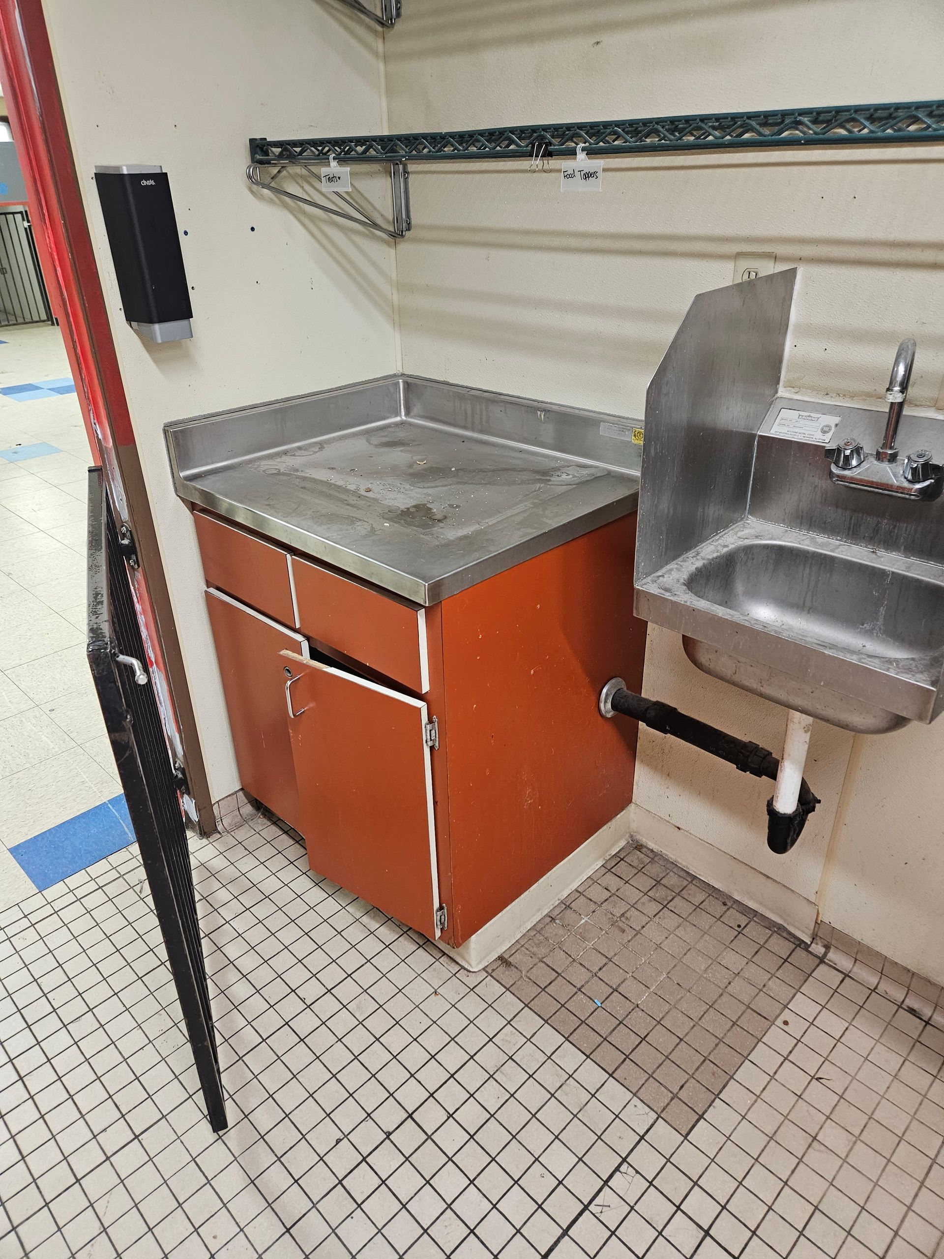 A kitchen with a sink and a counter top