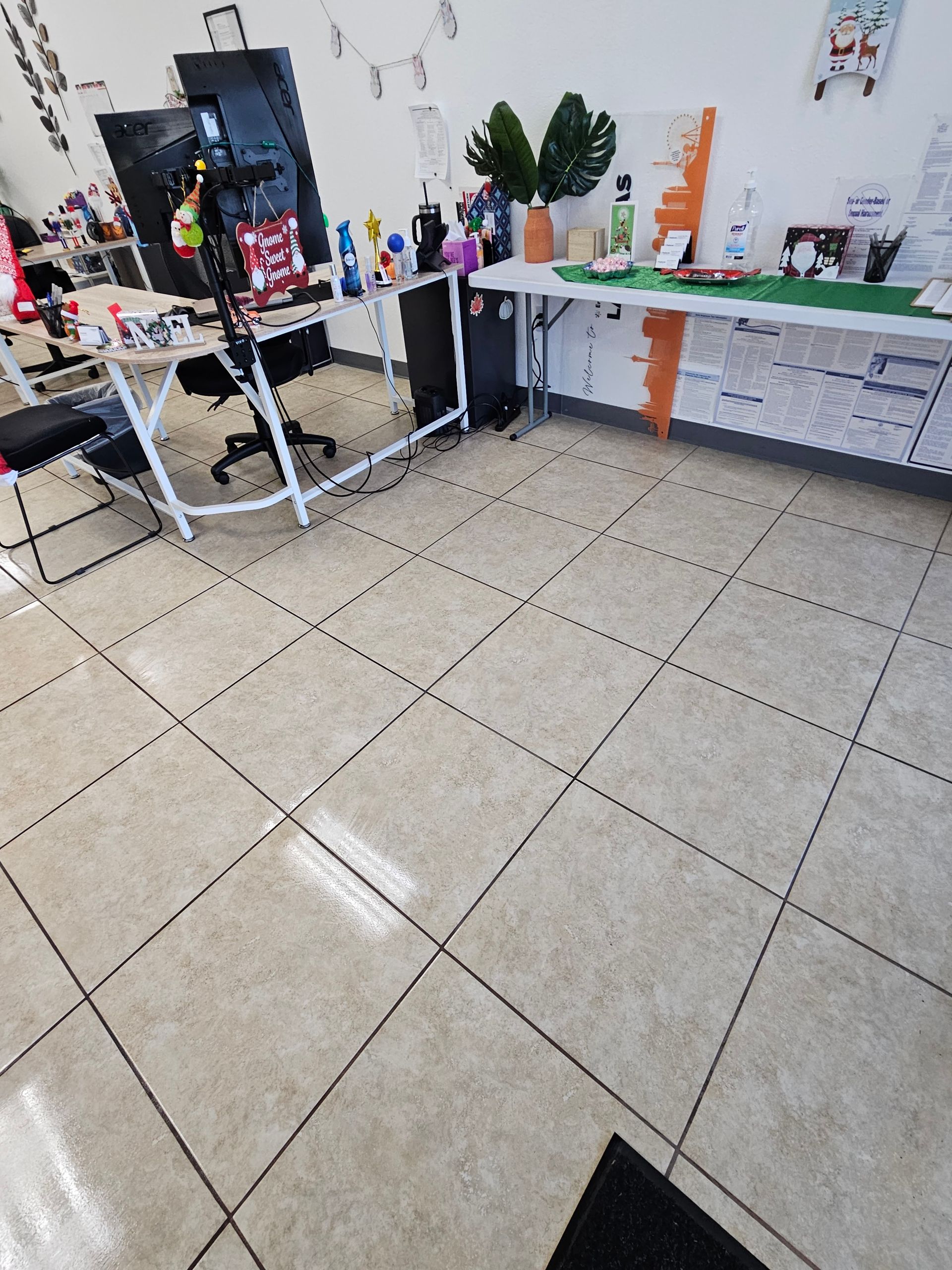 A tiled floor in a room with a desk and chairs