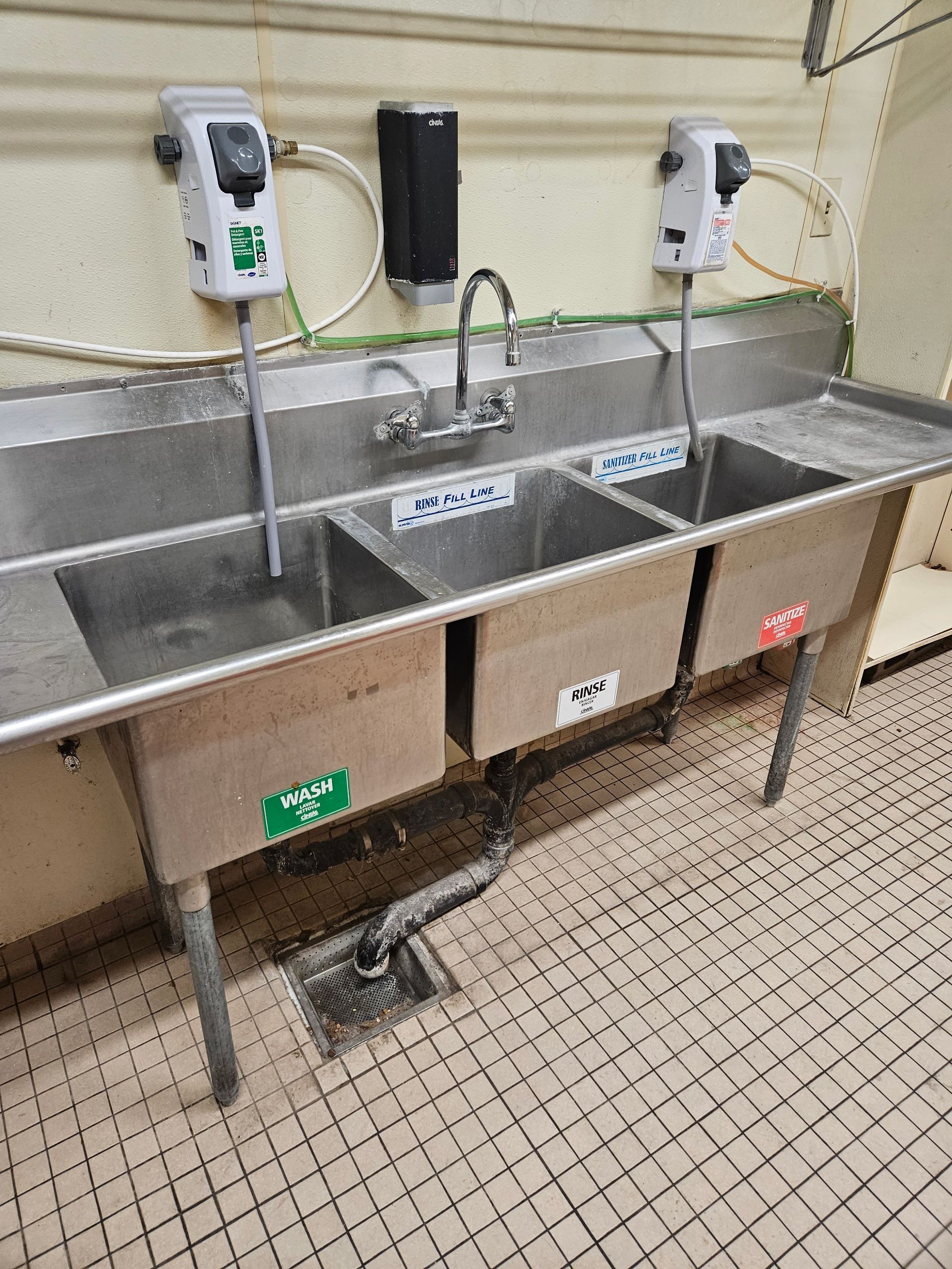 Two stainless steel sinks are sitting next to each other in a kitchen.