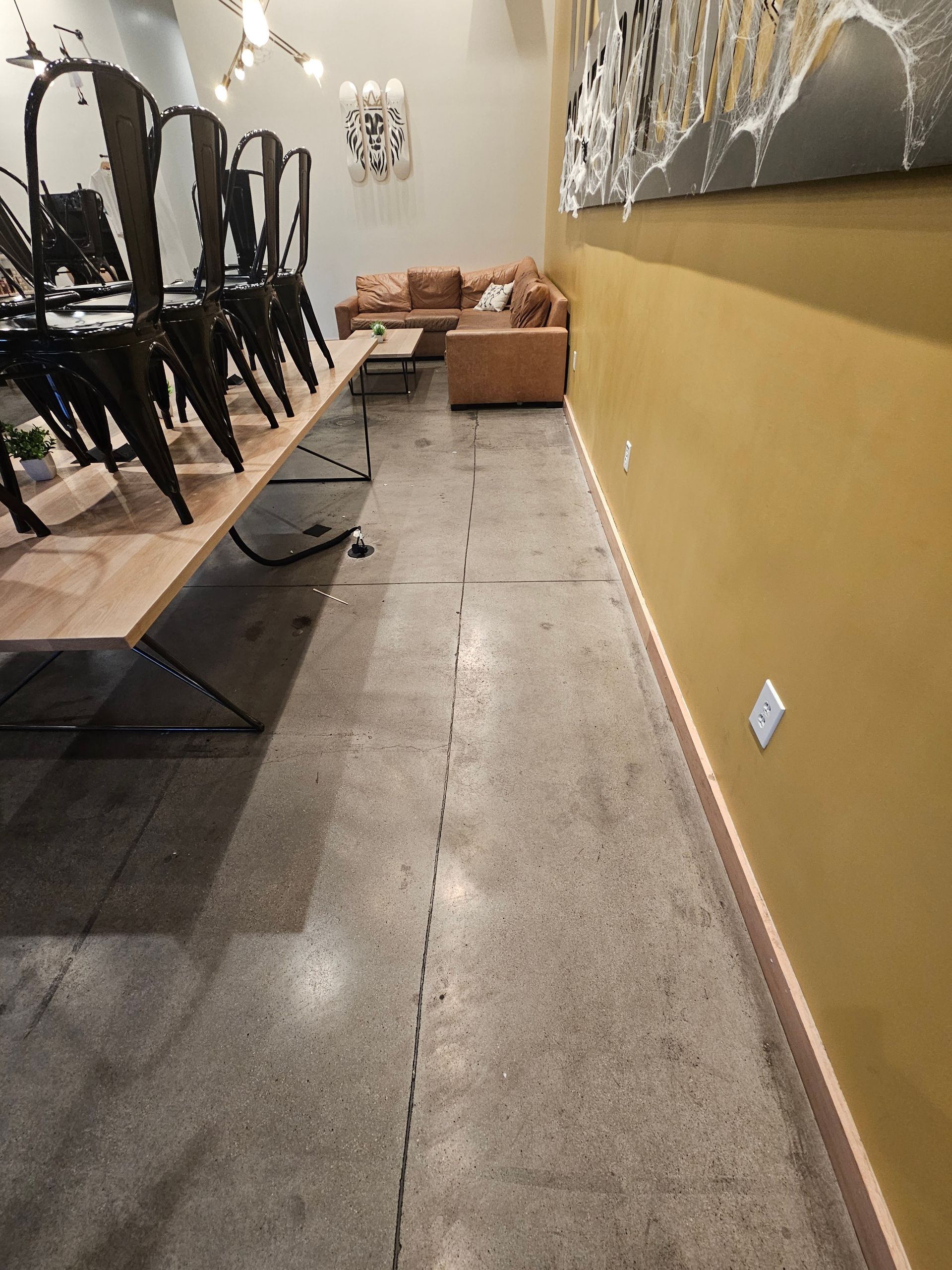 A long hallway with a couch and chairs in it