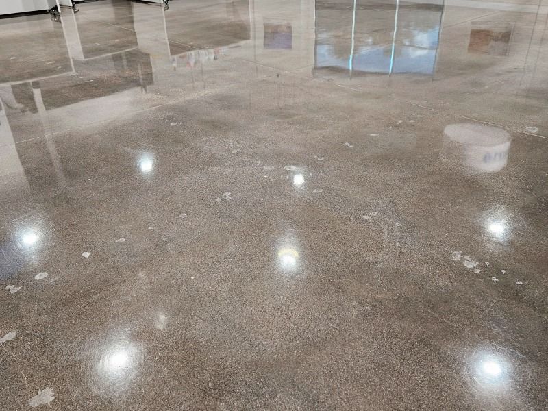 A close up of a shiny concrete floor in a room.