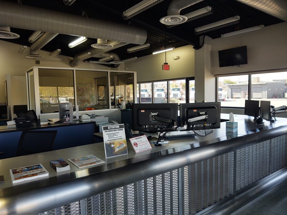 A very large office with lots of computers on the desks
