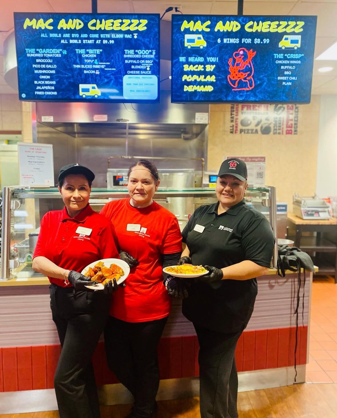 A group of chefs are posing for a picture in a kitchen.