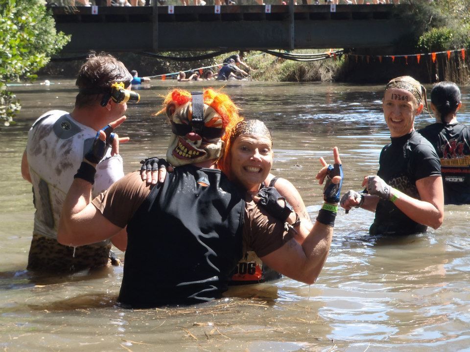 A group of people are standing in a body of water