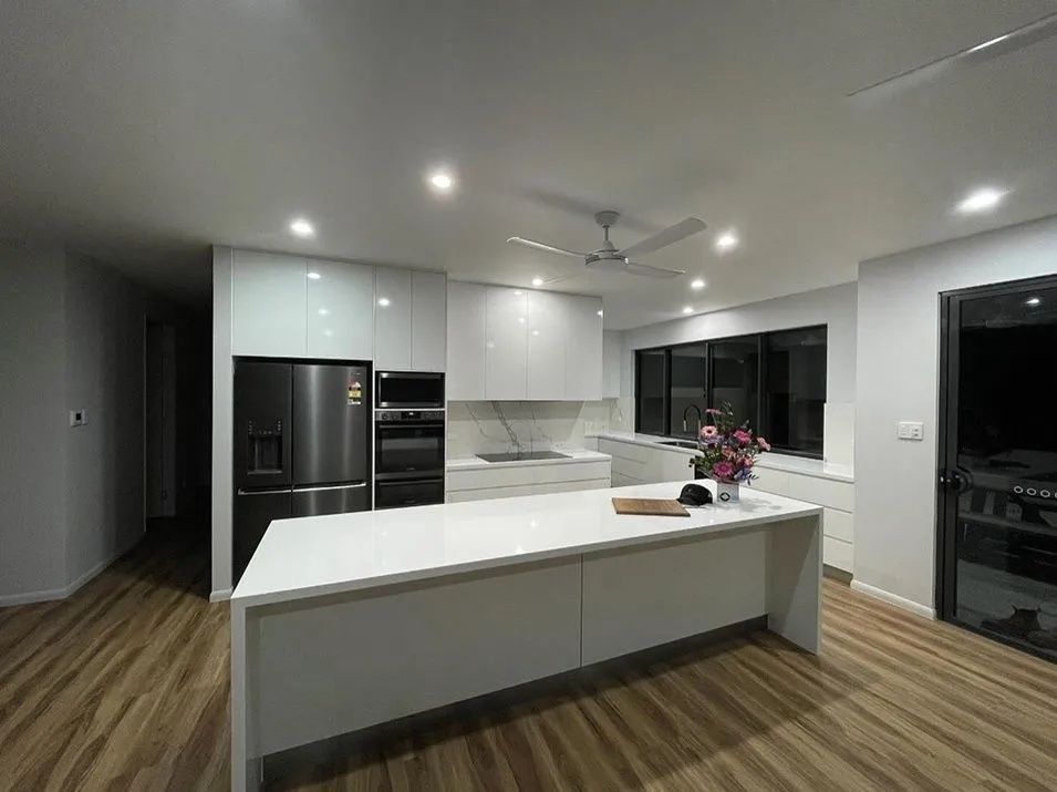 Modern White Kitchen With Island, Stainless Steel Appliances — Keilbach Kitchens in Cairns, QLD
