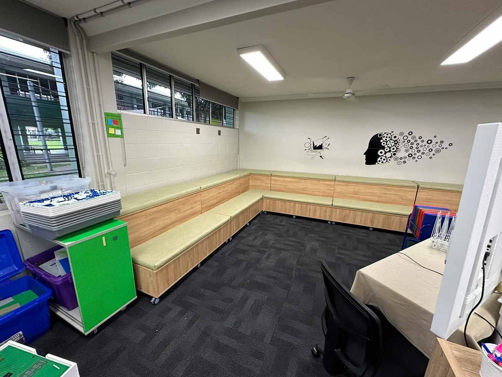 L-shaped Seating Area in a Room With a Black Carpet, a Green Cabinet, and a Desk — Keilbach Kitchens in Innisfail, QLD