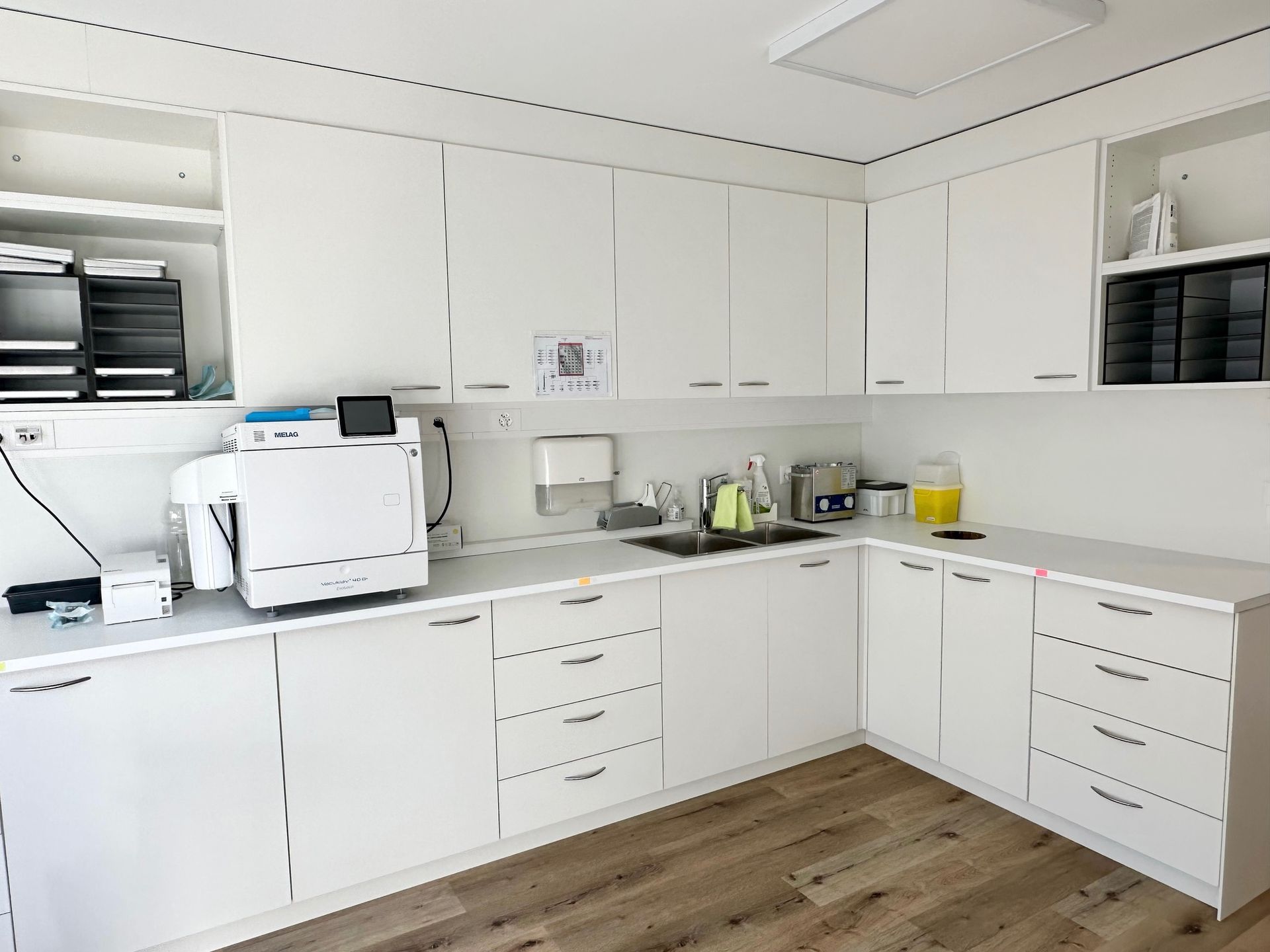 Une cuisine avec des armoires blanches et un évier.