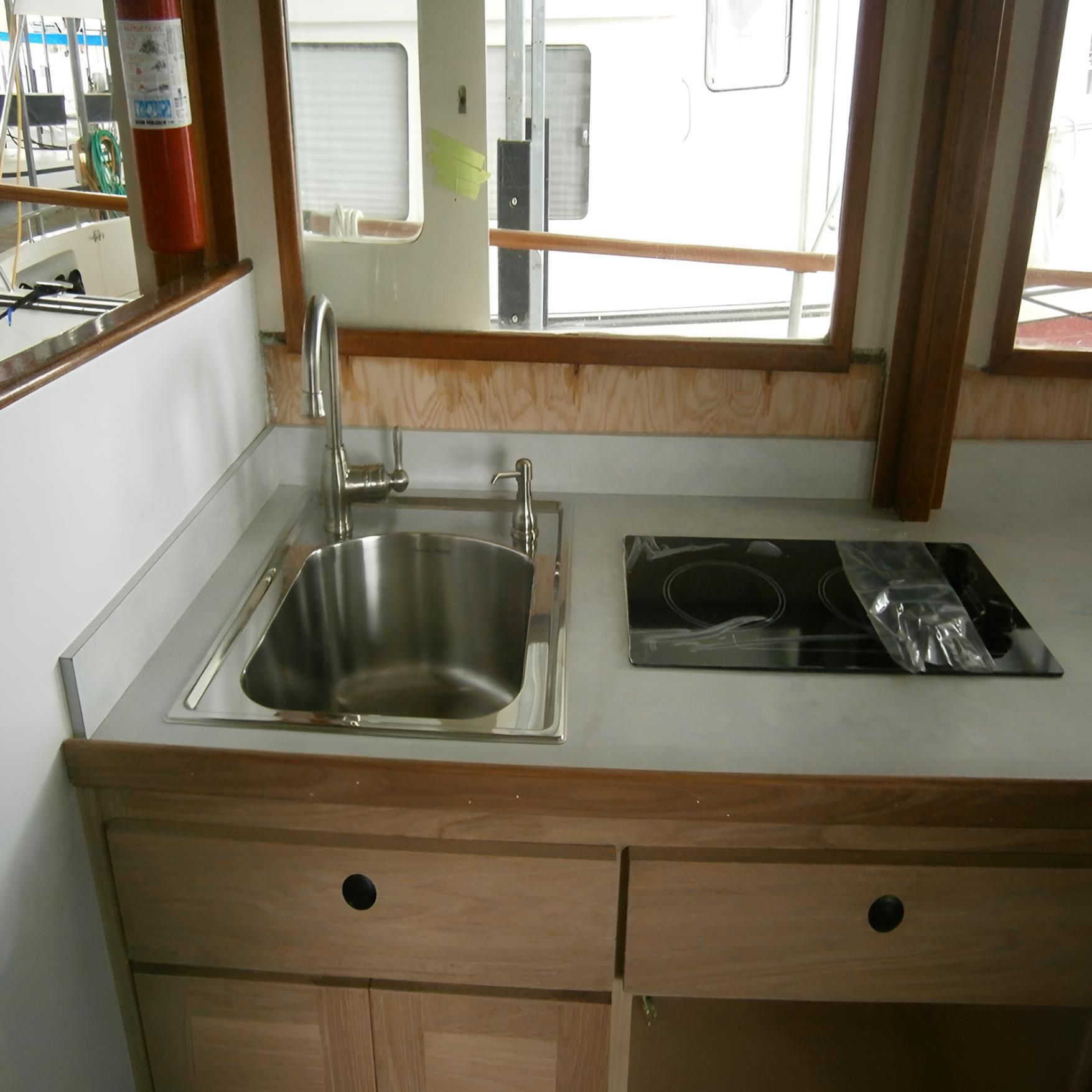 A Kitchen Counter With a Sink and Stove Top Oven — Proud Cleaning Canberra in Amaroo, ACT