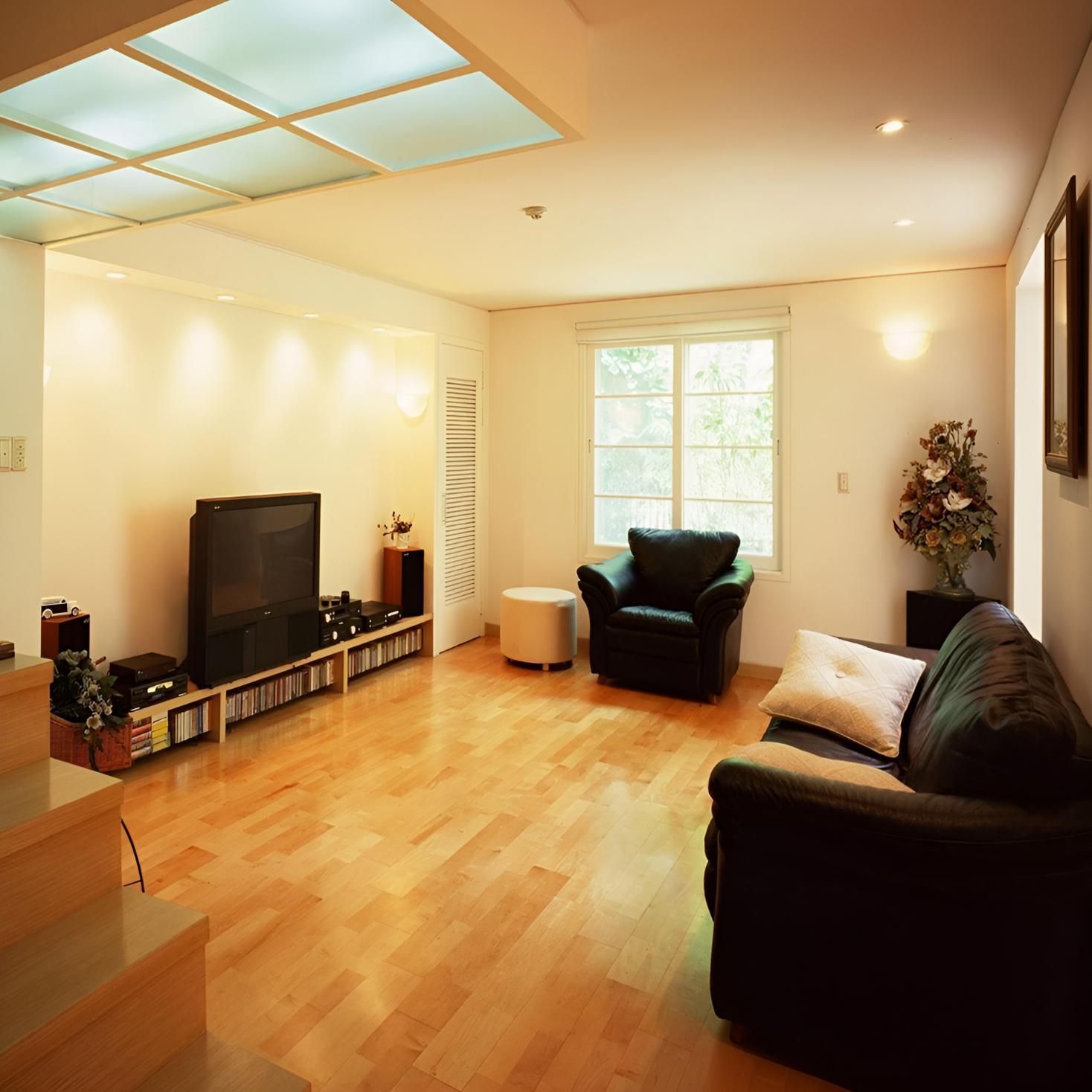 A Living Room With a Couch a Chair and a Flat Screen Tv — Proud Cleaning Canberra in Amaroo, ACT