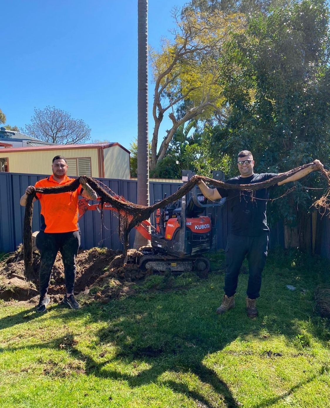 A man is kneeling on the floor with a toolbox full of tools.