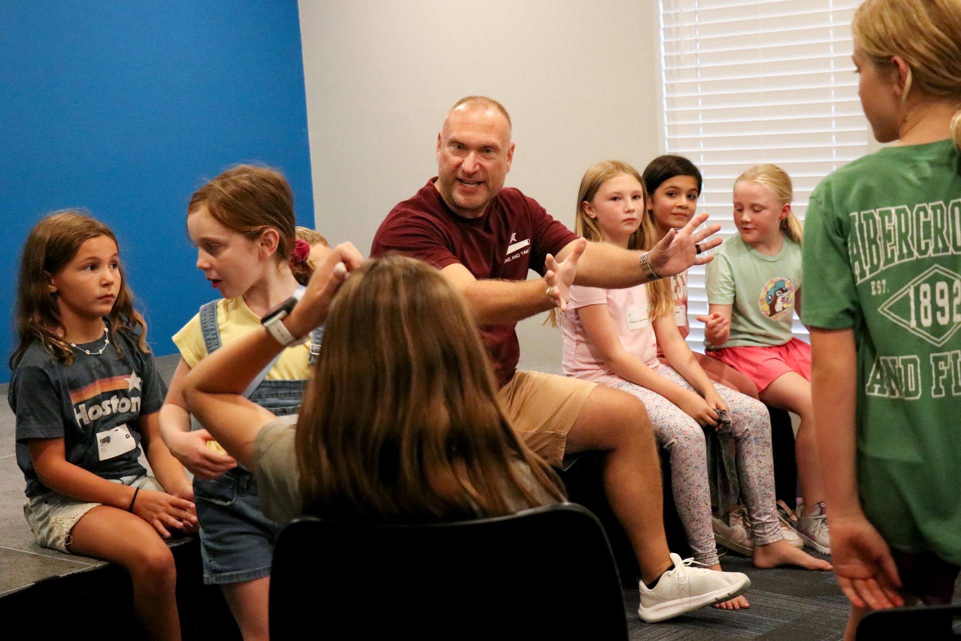 Teacher leading a small group discussion with children seated in a classroom circle