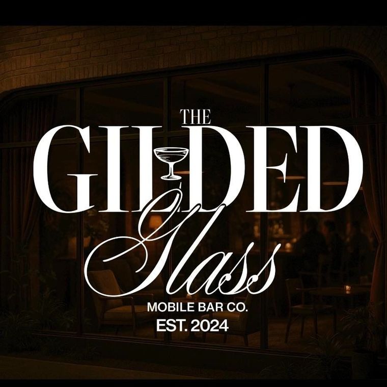 A logo for The Gilded Glass Mobile Bar Co., featuring white serif and script text overlaid on a dark, moody bar interior.