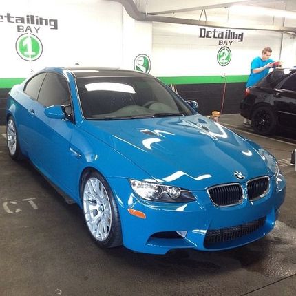 Blue BMW coupe in a detailing bay.
