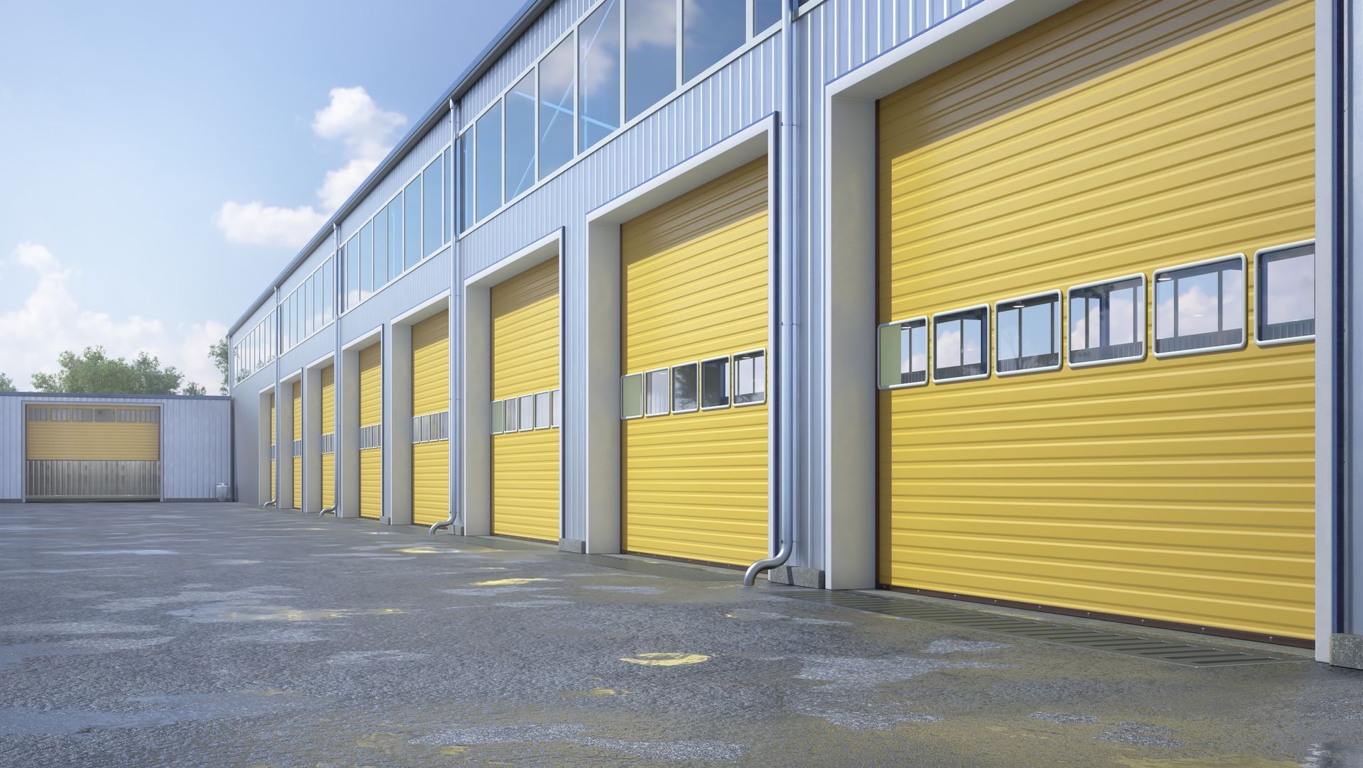 A row of yellow garage doors in front of a building.