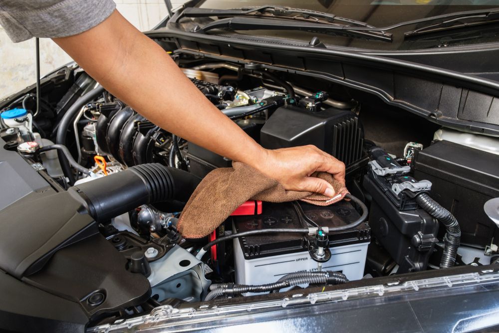 Person Cleaning A Car Engine With A Cloth — KND Autos in Berrimah, NT