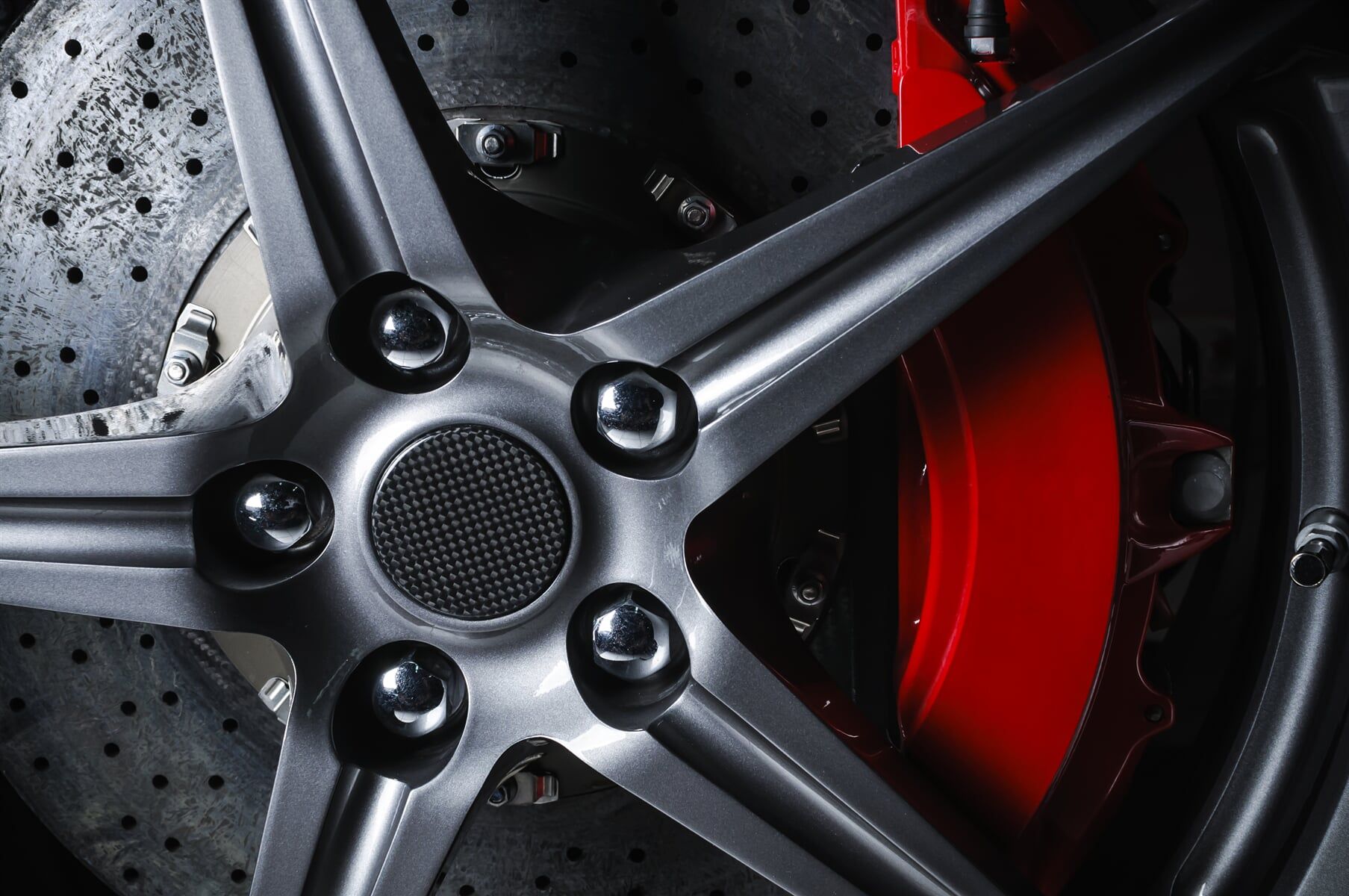 Close-up Of A Silver Car Wheel With A Red Brake Caliper — KND Autos in Berrimah, NT